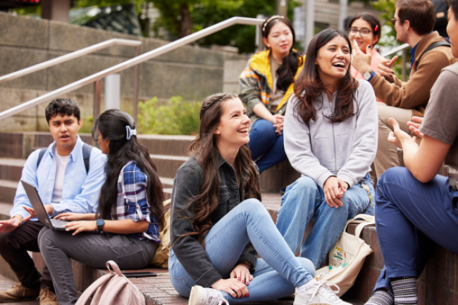 students sit outside 