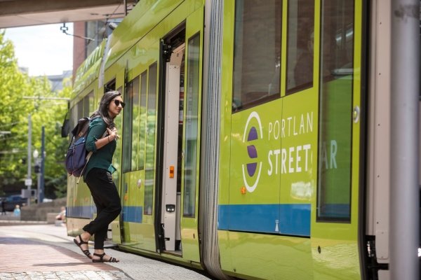 PSUF student getting on a Portland Streetcar