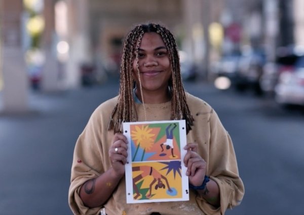 person holding their artwork